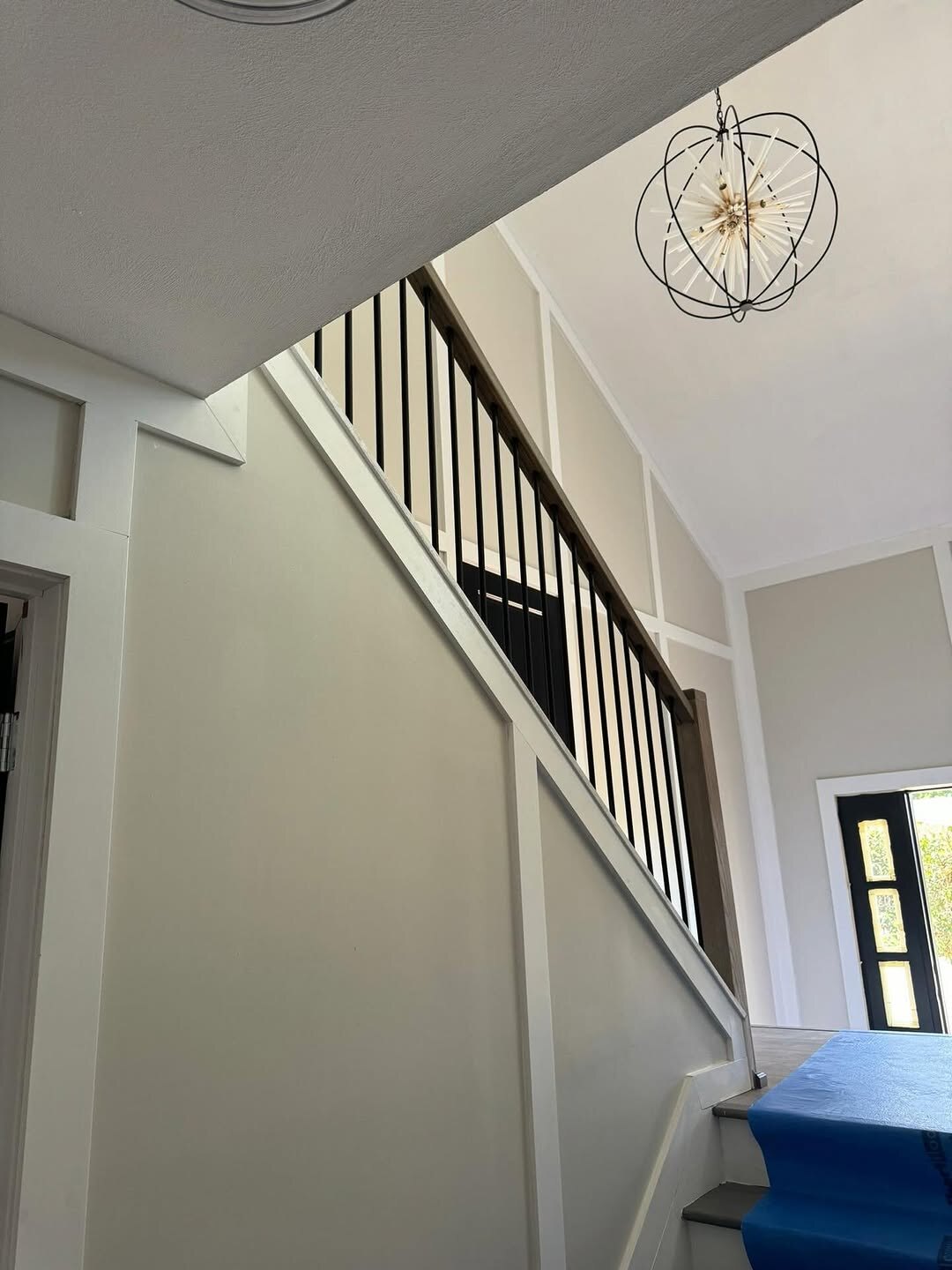 Custom staircase with iron railings by Limas Premier Construction