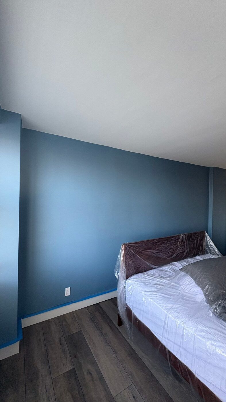 Bedroom painted in soft blue with white ceiling