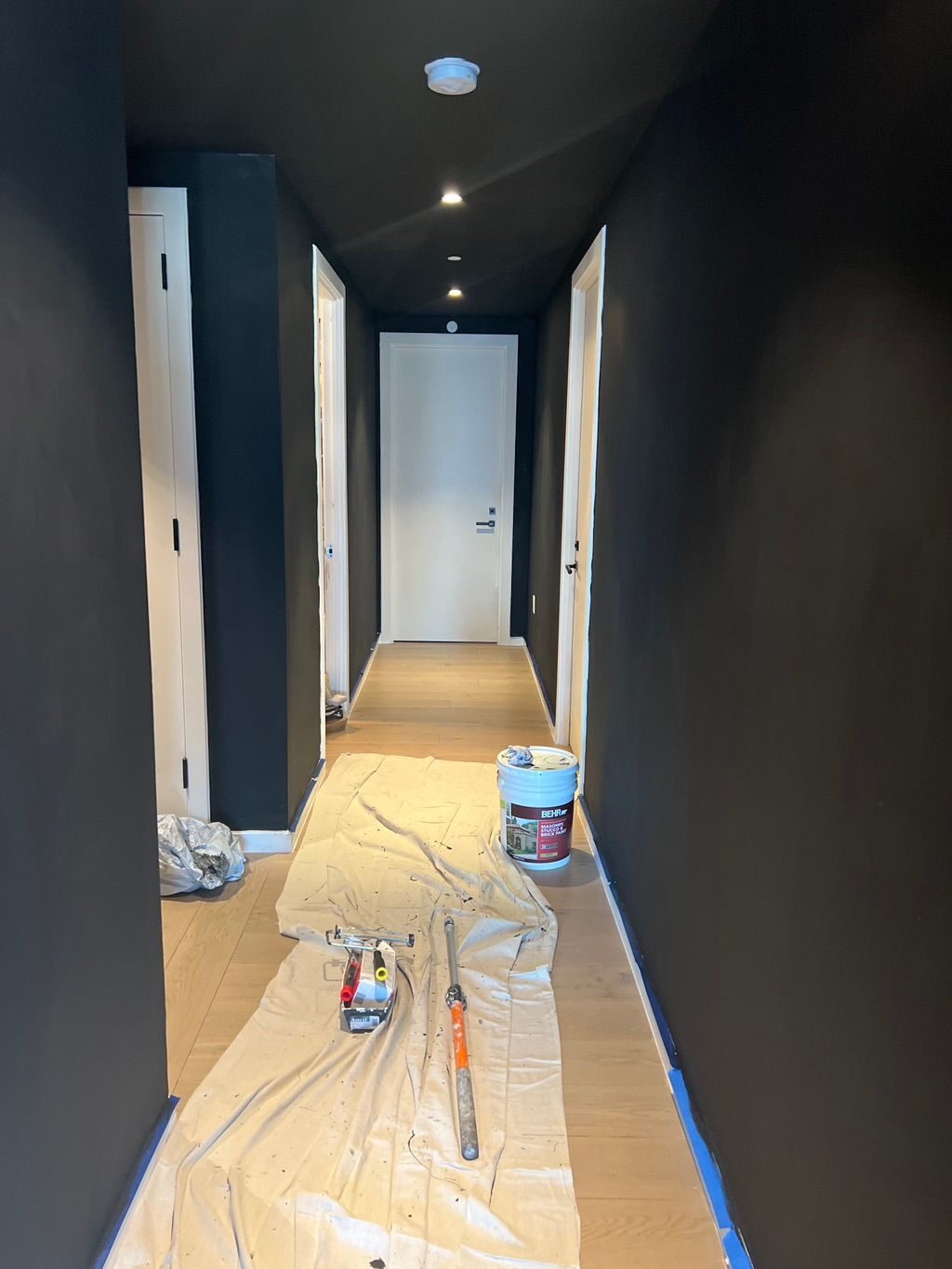 Hallway masked and floor-protected before painting