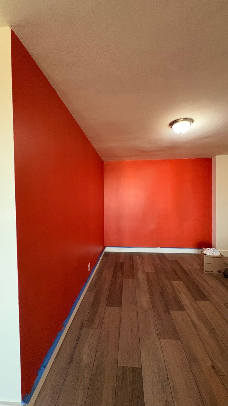 Hallway painted in deep red with white trim